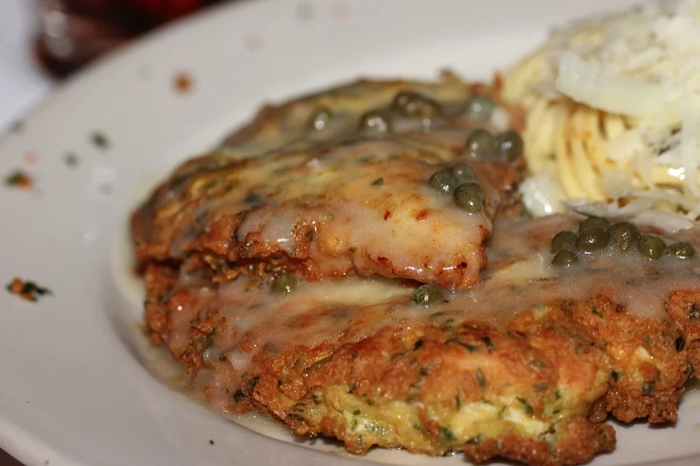 A plated Fenton Hotel entrée with capers and sauce